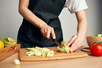 housewife in the kitchen cutting vegetables healthy eating vitamins