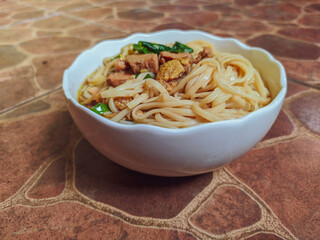 delicious chicken noodle with white bowl, with chicken and green vegetables composition
