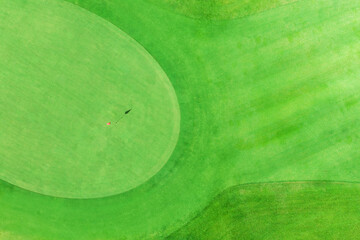 top view of golf pole on the green in a golf course