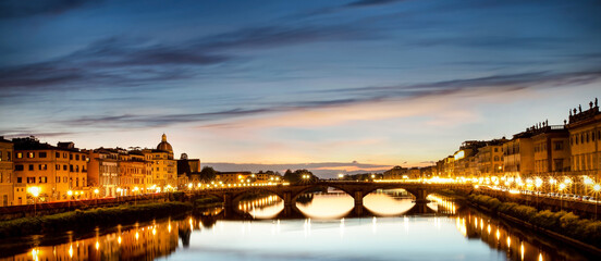 Panoramic view of Ponte Santa Trinita (Holy Trinity Bridge) over  Arno river  which View of after sunset down at Ponte Santa Trinita- Florence, Tuscany-Italy