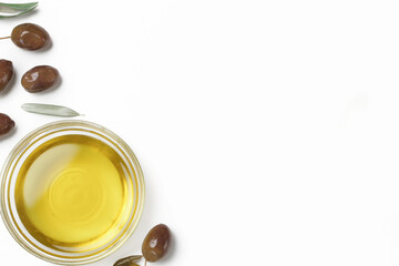Top view of extra virgin olive oil in bowl and olives isolated on white background.