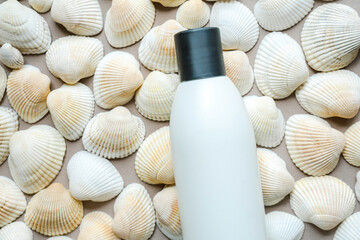 Natural cosmetics based on sea minerals. Concept made with white bottle and sea shells.
