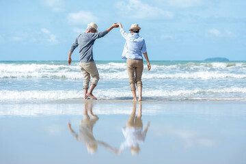 Retirement Travel. Asian Lifestyle senior couple dancing on the beach happy and relax time.  Tourism elderly family travel leisure and activity after retirement in vacations and summer.