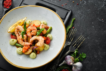Baked shrimp with potatoes and vegetables. Top view. Free space for text.