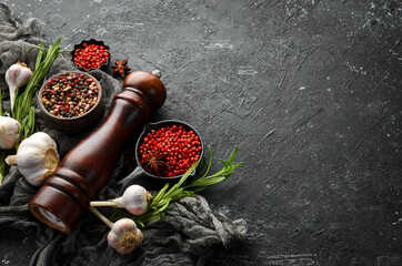 Assortment of peppers and spices on a dark background. Top view. Free space for your text.