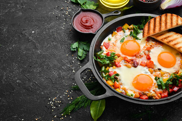 Shakshuka. Fried eggs with vegetables in a frying pan. Top view. Traditional cuisine of Israel.