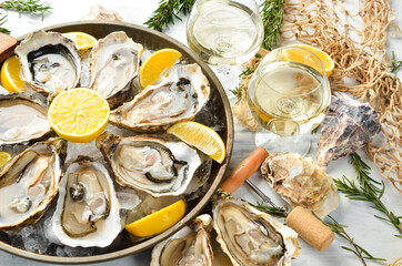 Fresh opened oysters and white wine and lemon. Free space for your text. Seafood. Flat lay.