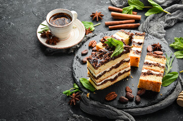 Slices of sweet creamy chocolate cake. Dessert. On a black background. Top view.