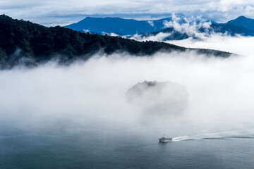 A boat emerging from the fog