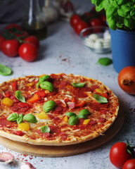 Pizza with salami and basil