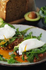 Homemade sandwiches with salmon, avocado and poached eggs	