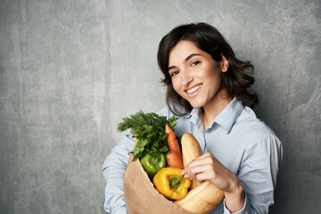 pretty woman with a package of groceries vegetables delivery shopping