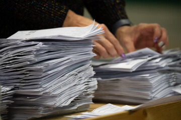 counting ballot papers at polling station during election