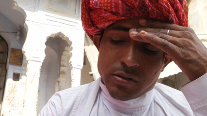 Indian young man in traditional Indian clothing looking sad and depressed