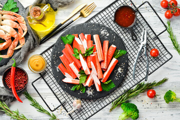 Crab sticks with spices on a plate. Cooking salad. Rustic style. Seafood delicacies. © Yaruniv-Studio