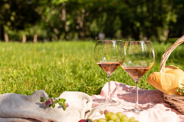 Romantic picnic with wine in a summer garden