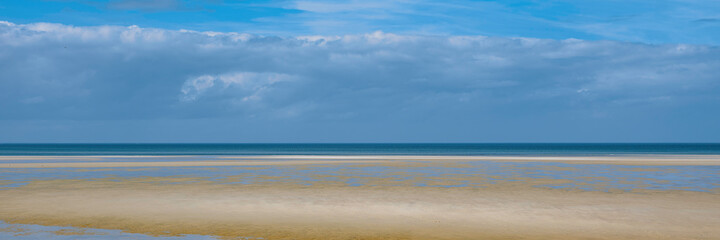 Abstract topography of dramatic sky, calm sea, and clean beach on Cape Cod. Tranquil seascape at...