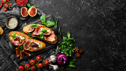 Bruschetta with prosciutto, figs and feta cheese. Antipasto. Top view.