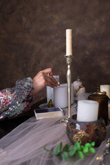 Fortune telling on tarot cards, candles for magic rituals.