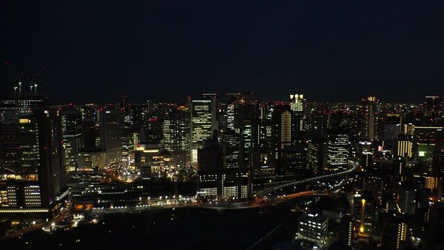 UMEDA, OSAKA, JAPAN : Aerial high angle view of CITYSCAPE of OSAKA at night. View of buildings and street around Osaka and Umeda station. Wide view real time shot.