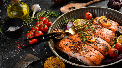 Baked Salmon with rosemary, lemon and vegetables. Recipe. Seafood. Side view Free space for text.