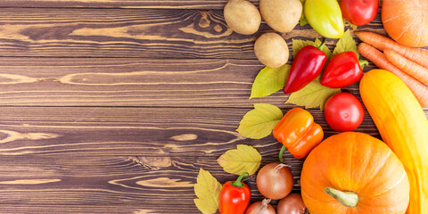Autumn harvest still life. Fresh Organic Vegetables On Wooden Surface. Top view with copy space, banner size.