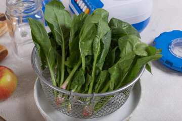 Ingredients of fruit smoothie with spinach on the table close-up. Bananas, apples, spinach, honey