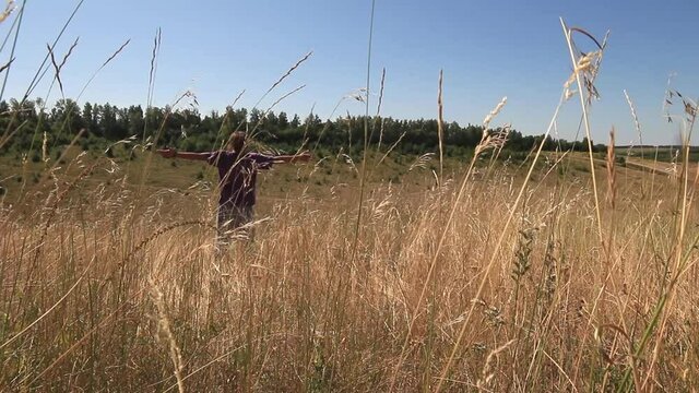 the grass sways in the field, the man falls into the grass