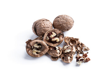 heap of cracked walnuts isolated on white background top view