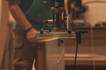 an adult man working in a carpentry workshop.
