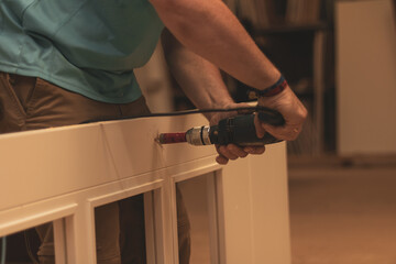 an adult man working ian adult man working in a carpentry workshop.n a carpentry workshop.