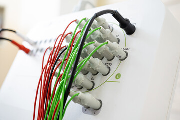 Encephalograph with green and red wires at modern medical center