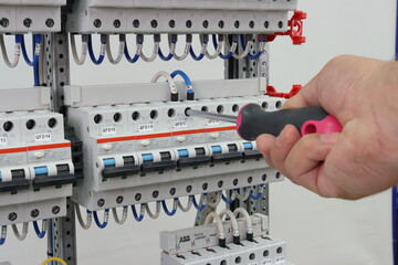 The engineer installs automatic protection devices in the electrical panel