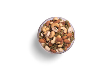 many snack nuts pumpkin seeds, pistachios, macadamia nuts, cashew nut, almond in glass bowl on white background. Vegetarian or vegan snake. Healthy food eating. Top view