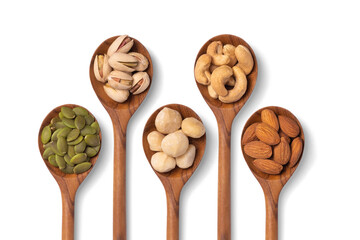many snack nuts pumpkin seeds, pistachios, macadamia nuts, cashew nut, almond in wooden spoon on...