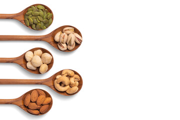 many snack nuts pumpkin seeds, pistachios, macadamia nuts, cashew nut, almond in wooden spoon on...