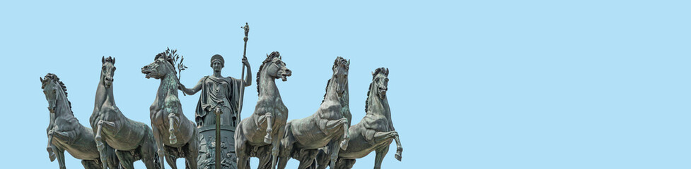 Banner with statue of Goddess Victoria with horses at the top of Triumphal Arch called Arch of Peace in Milan historical downtown, Sempione Park, Italy, at blue sky background with copy space - obrazy, fototapety, plakaty