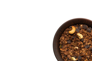 Chocolate granola cereal with nuts in a bowl background.