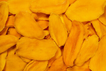 Dry sugar mango slices as a background.