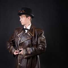 Funny man in a ridiculous leather coat and a top hat,