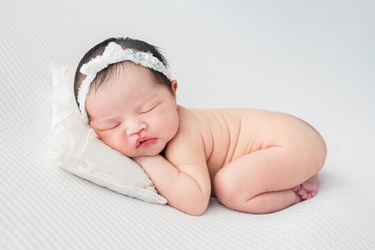 Cute  baby lying on the white  blanket.