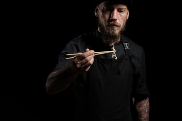 Chef holding white bean sprouts with chopsticks