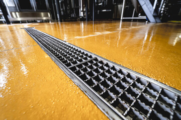 stainless steel floor drain at a modern beer factory