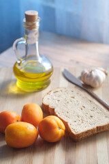 close up of garlic , tomato and olive oil on table 