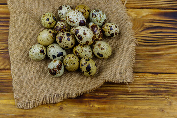 Quail eggs on a wooden table. Top view