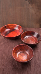 Empty wooden bowl and wooden spoon isolated with copy space.