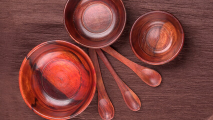 Empty wooden bowl and wooden spoon isolated with copy space.