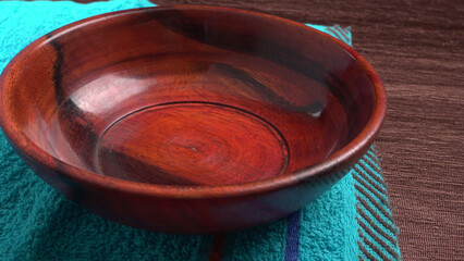 Empty wooden bowl and wooden spoon isolated with copy space.