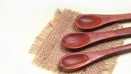 Empty wooden bowl and wooden spoon isolated with copy space.