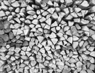 Background of chopped wood lying on top of each other. Pile of chipped wood close-up. Black and white photo